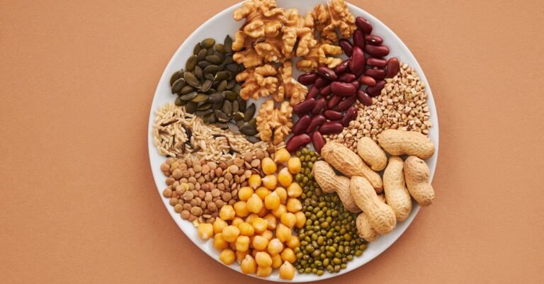 Top view of nuts, beans, and seeds on a plate, ideal for healthy dining themes.
